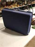 Large blue samsonite suitcase with key