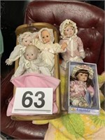 5 dolls and cradle