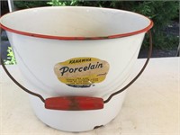 Kanawha enamel bucket with wooden handle grips.