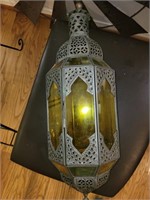 Ornate metal and yellow glass hanging lamp.
