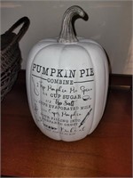 White ceramic pumpkin with pumpkin pie recipe on t
