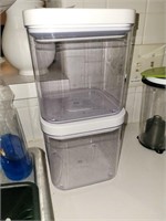 Two plastic storage containers. With pressure