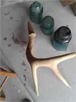 THREE INSULATORS AND PLASTIC DEER HORN