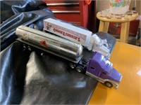 TWO TOY SEMI TRUCKS WITH TRAILERS