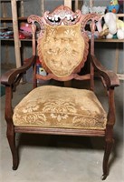Ornately carved wooden chair with decorative