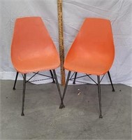 2 orange mid century chairs