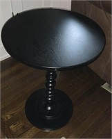 Round single pedestal table, black color. 18”
