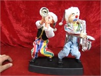 2 clowns playing trumpet/saxophone.