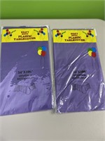 2 purple plastic tablecloths - 54x108in