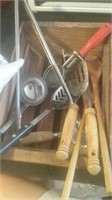 Kitchen utensils in a small wooden crate