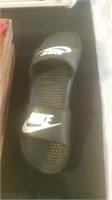 Pair of smaller black and white Nike Slides