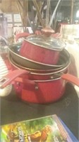 Stack of clean red pots and pans