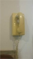 Vintage yellow rotary dial wall phone