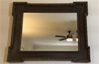 Large framed carved wood wall mirror.  Frame is