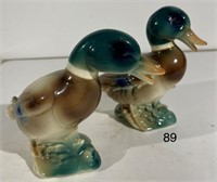 Pair of Glazed Porcelain Squabbling Mallard Ducks