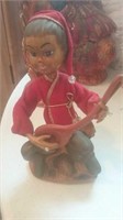 Wood carved figure playing instrument