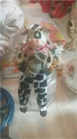 Cow sitting on jar decor