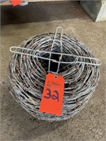 Roll of red tipped barbed wire
