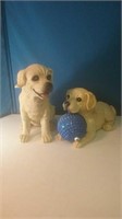 Pair of resin puppies one holding a blue holiday