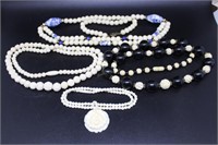 Four carved bead necklaces incl blue & white cera