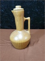 Pottery decanter with lid bottom is marked USA