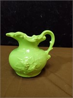 Lime green pitcher with grape and leaf motif