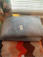 Blue quilt with  other items below it