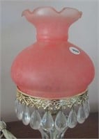Antique table lamp with ruffled edge and prisms.