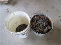 two buckets with pieces of chains