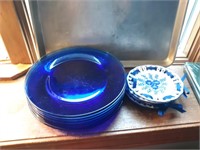 Decorative plates and 7 blue glass dinner plates