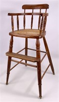 Oak child's highchair, cane seat, bent wood arms,