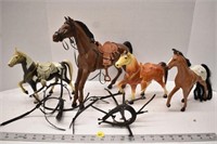 Four plastic horses and accessories