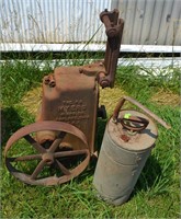 Pump jack and galvanized garden sprayer canister.