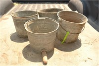 4 galvanized buckets. one is a Calf-teria nursing