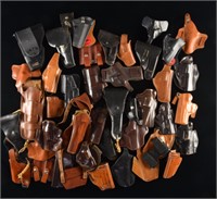 LARGE ASSORTMENT OF HOLSTERS AND RELATED ITEMS.