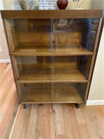 Wooden bookcase with glass front
