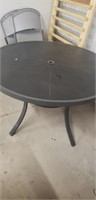Black outdoor round table with hole for umbrella