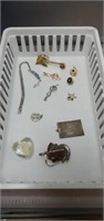 Assorted necklace pendants, lapel pins, bookmark