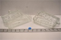 Two glass covered butter dishes