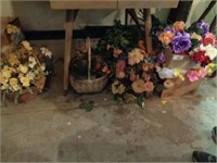 Misc flowers and baskets under table