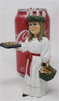 Girl with cookies on a cookie sheet and basket