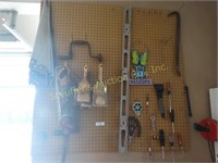 Pegboard contents:  saws, brushes, level, prise