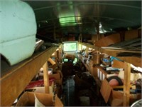 Bus full of old car parts some new.