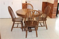 Five piece oak table and chairs,