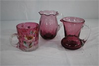Two cranberry glass pitchers 3.5 and 4"