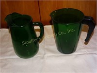 2 Green glass pitchers 7" tall