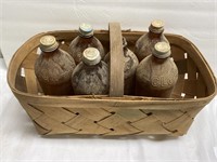 Basket and (5) vintage amber Clorox bottles
