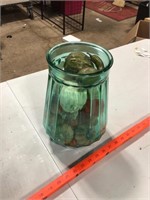 Large green or blue glass vessel with contents