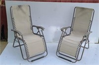 Two folding Chaise lounge chairs.