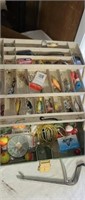 Fishing tackle box full of gear.